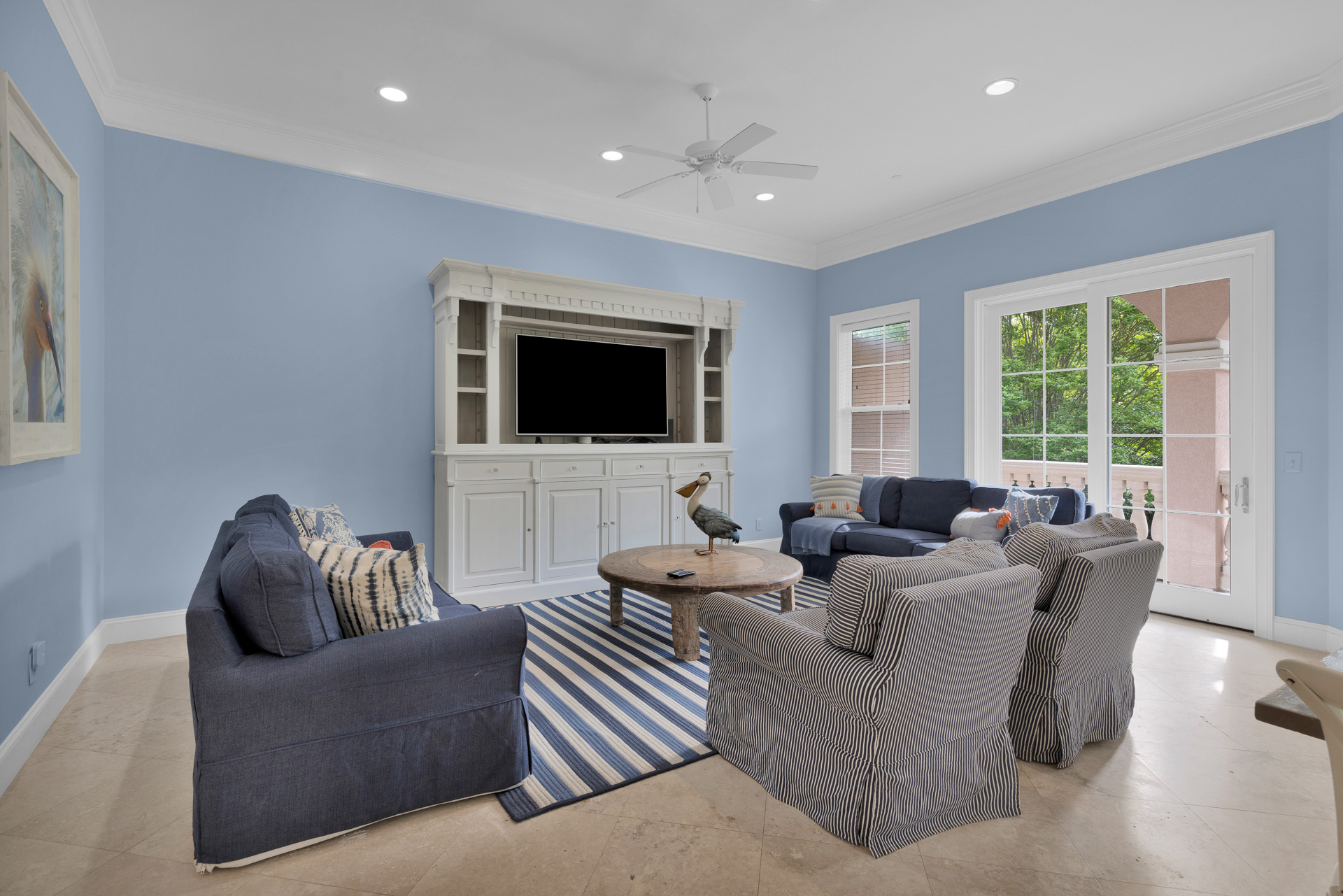 Spacious living room with full seating and balcony access
