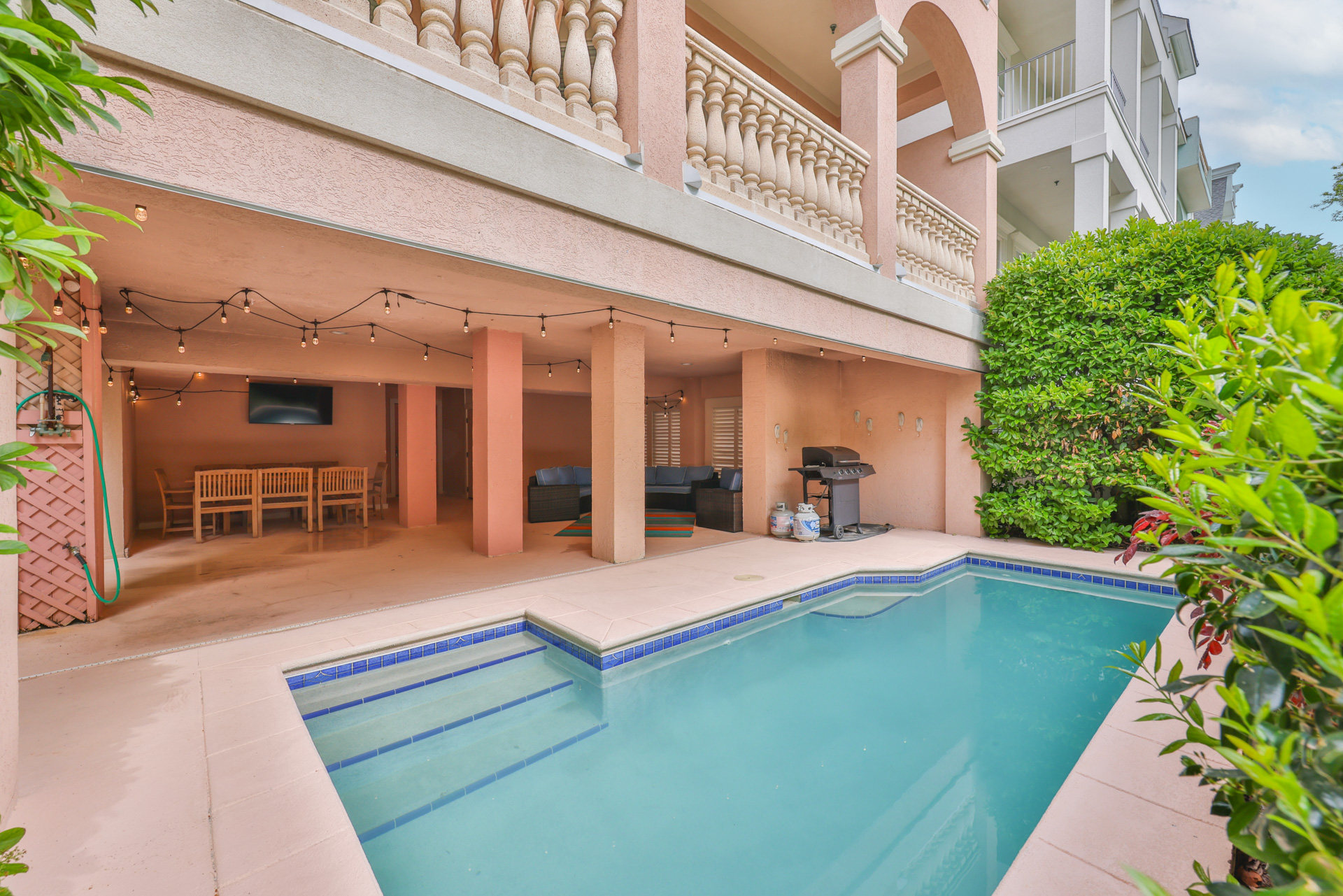 Pool and full outdoor entertaining area with BBQ grill and balconies above